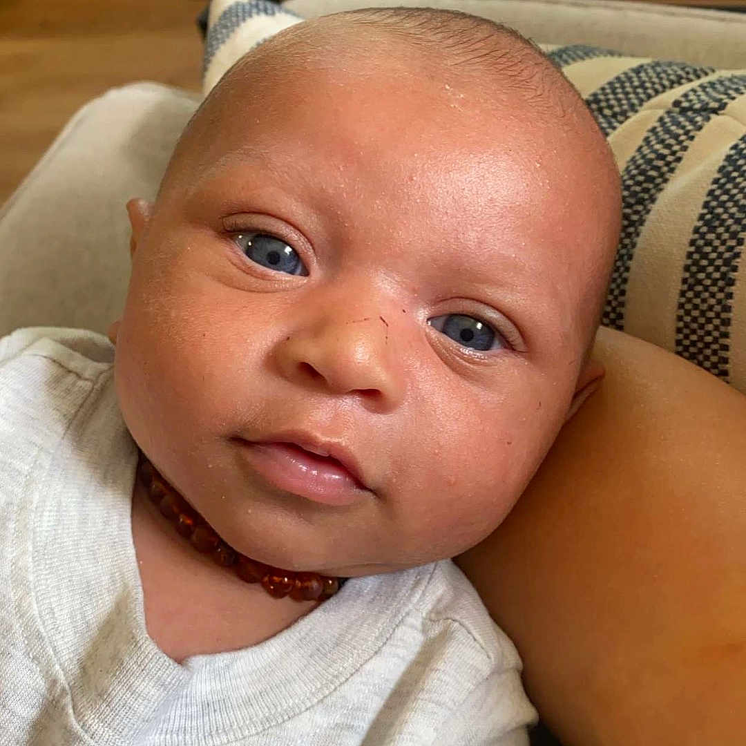 Kyland is registered to the contest to win money with this photo: accessories, baby, clothing, couch, cushion, face, furniture, happy, head, homedecor, jewelry, necklace, newborn, person, photography, portrait, selfie, skin, smile, t_shirt