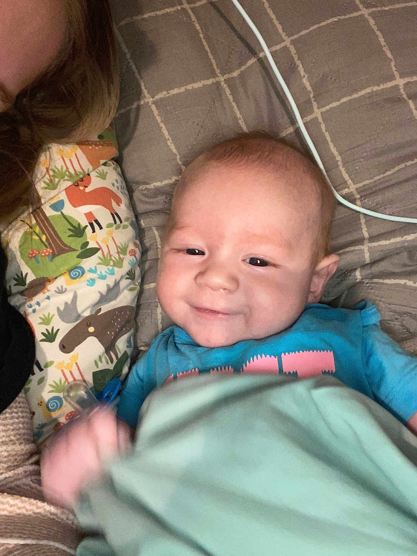 Karsyn joined the competition — help win amazing prizes! baby, infant, smile, blanket, pillow, animal_print, pacifier, blue_shirt, bed, cozy, cute, child, person, resting, happy, indoors, soft_lighting, head, face, young