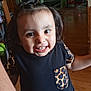 Amy is registered to the contest to win money with this photo: toddler, child, smile, happy, indoor, black_shirt, leopard_print, face, eyes, hair, person, wooden_floor, joy, curiosity, casual_clothing, cute, young_child, portrait, standing, home