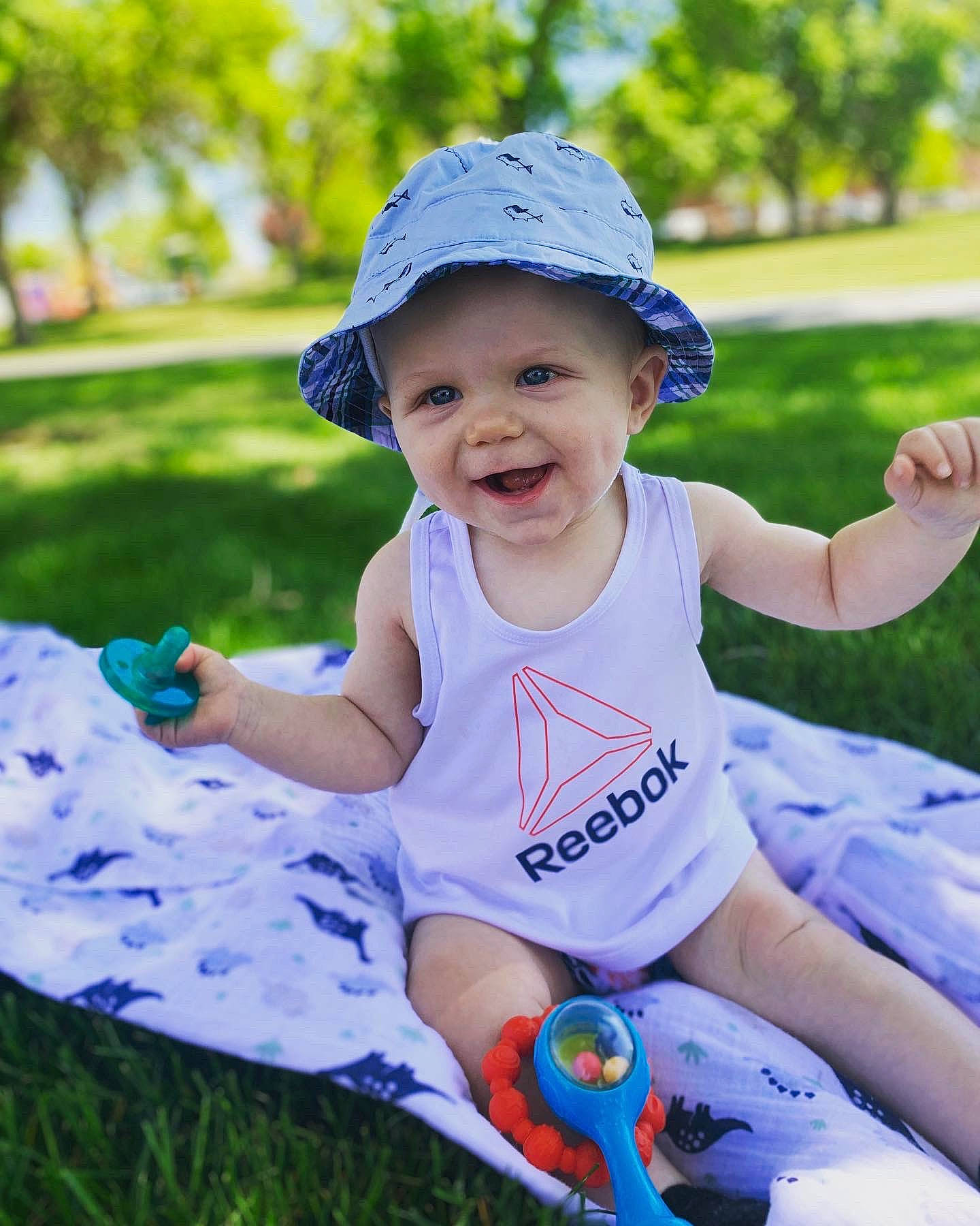 Kru joined the competition — help win amazing prizes! baby, baby_toddler_clothing, cap, grass, green, happy, hat, headgear, headwear, leaf, leisure, light, people_in_nature, person, photograph, pink, plant, product, smile, sun_hat
