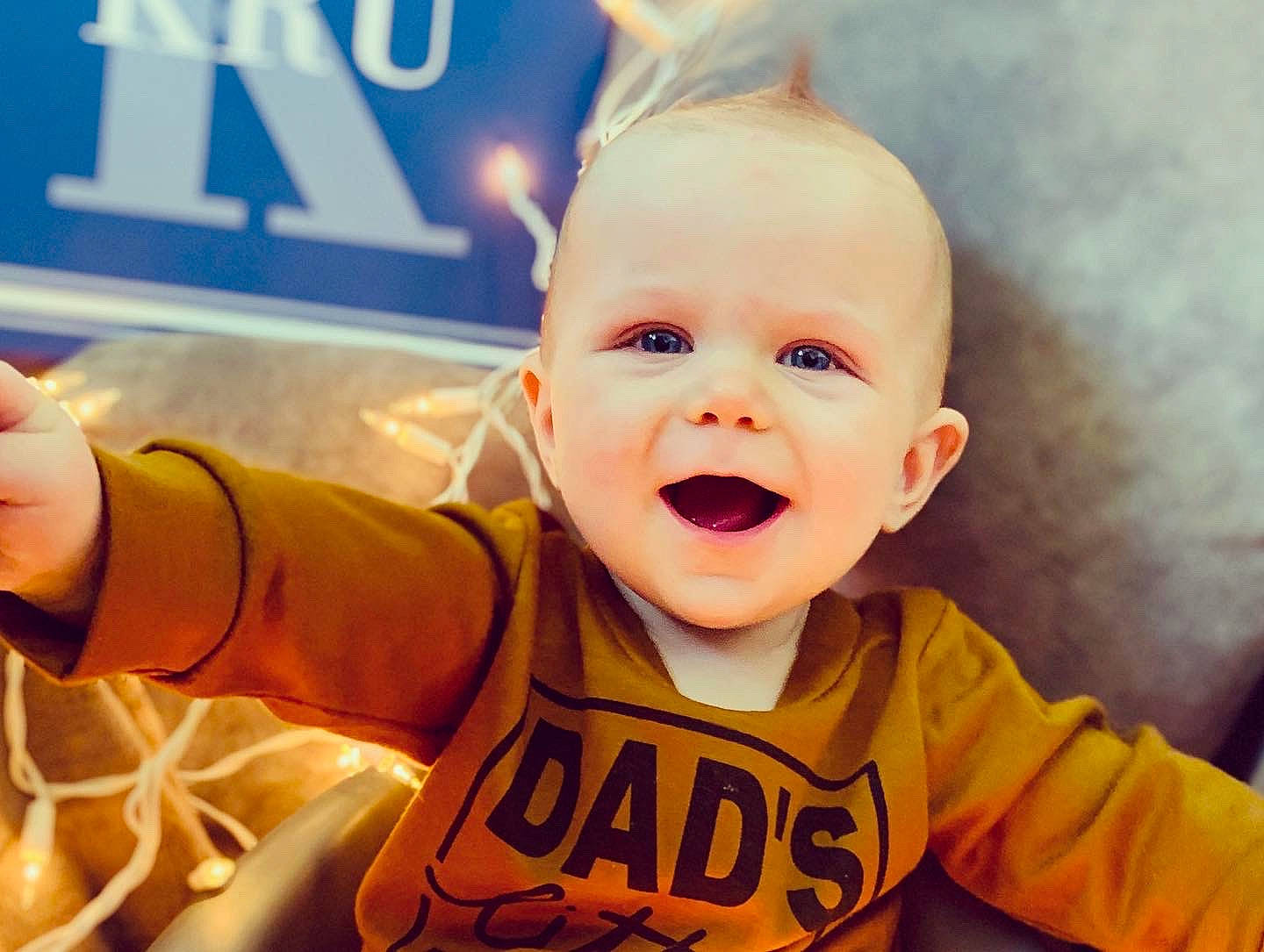 Kru joined the competition — help win amazing prizes! arm, baby_toddler_clothing, cheek, chin, clothing, eye, eyebrow, finger, gesture, hand, happy, iris, mouth, nose, orange, outerwear, person, shirt, sleeve, smile