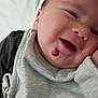 Xavier is registered to the contest to win money with this photo: baby, smiling, face, closeup, infant, clothing, gray, skin, child, cute, happy, head, portrait, newborn, resting, young, person, indoors, cozy, expression