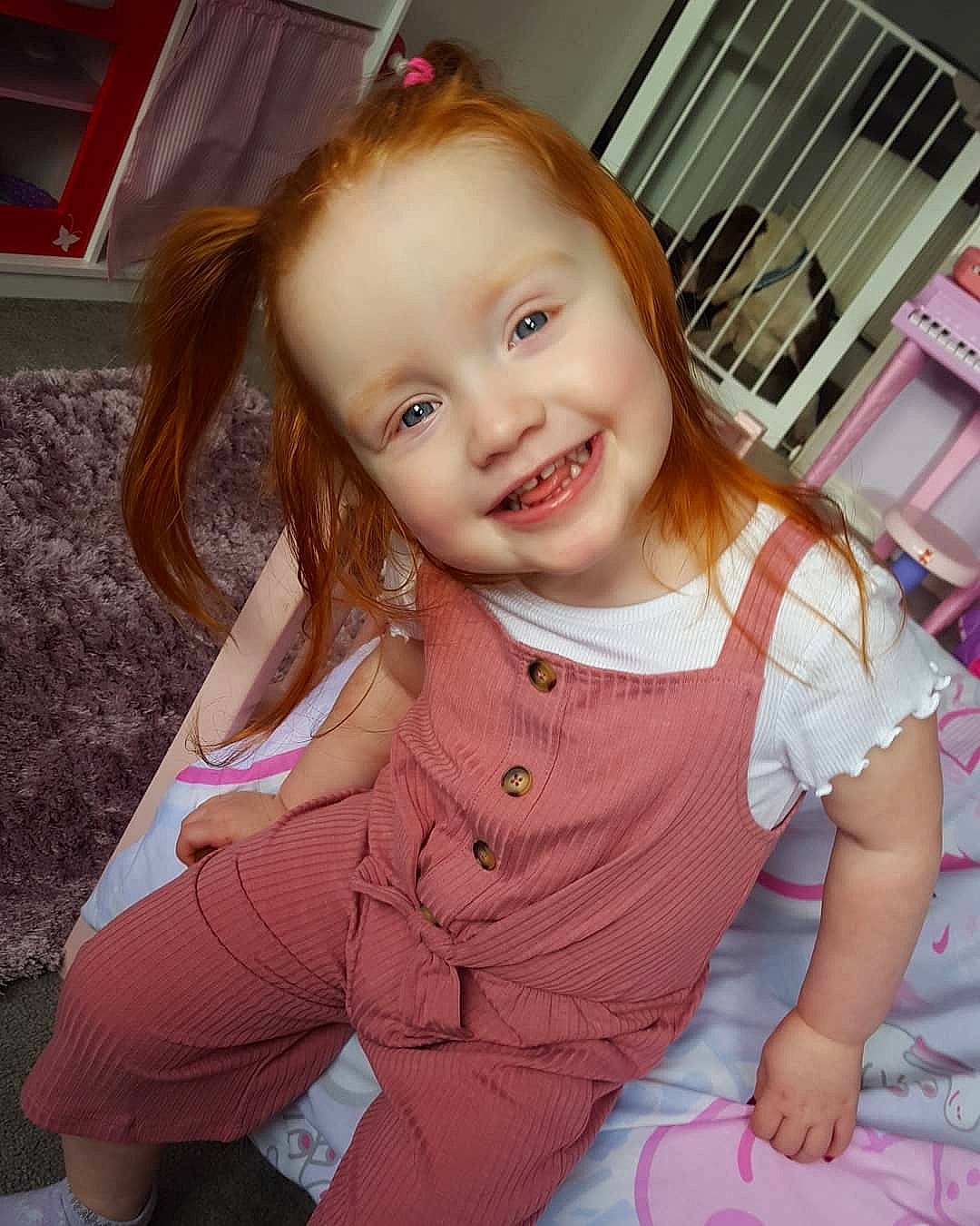 Delilah is registered to the contest to win money with this photo: baby, beauty, brown_hair, cheek, child, child_model, eye, face, facial_expression, fun, hair, happy, head, iris, joy, long_hair, person, pink, sitting, skin