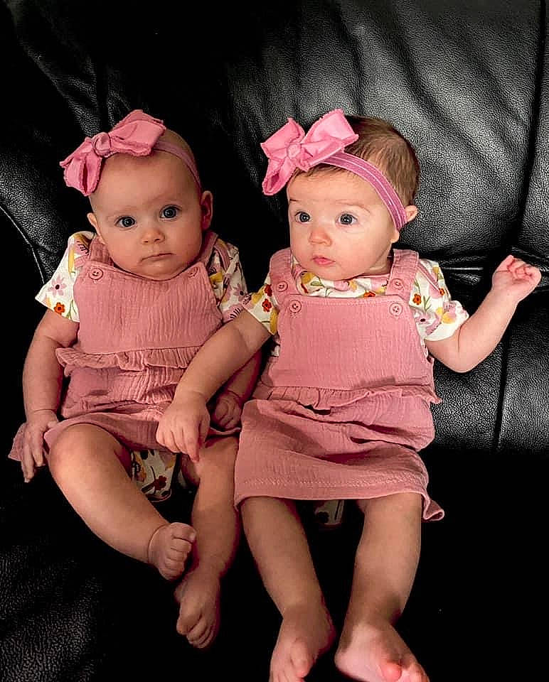 Ensley And Rylann joined the competition — help win amazing prizes! baby, cheek, child, dress, eye, face, fun, hair_accessory, head, headgear, human, iris, people, person, photography, pink, product, sibling, sitting, skin