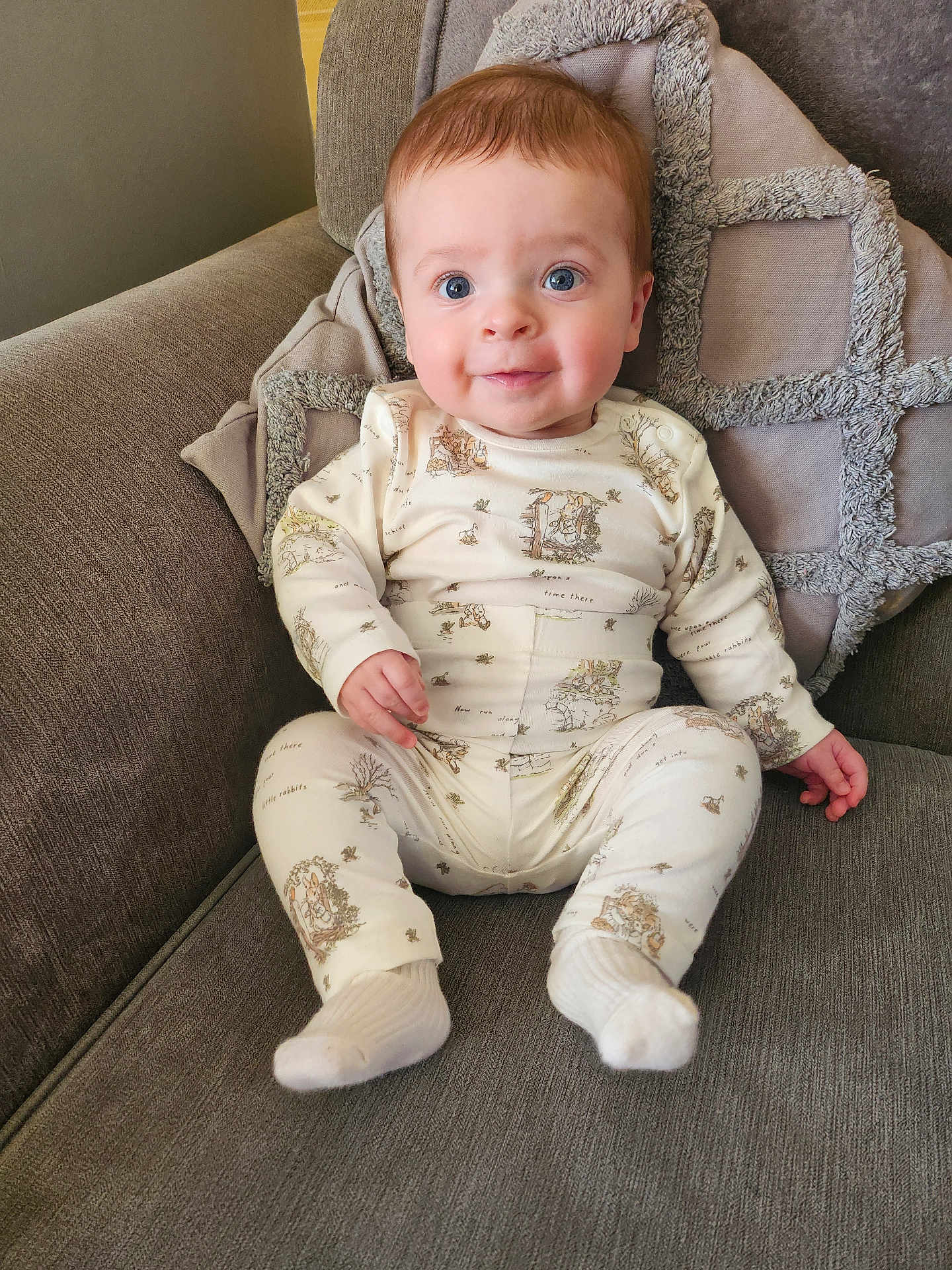Frankie is registered to the contest to win money with this photo: baby, bodypart, chair, clothing, couch, cushion, face, finger, furniture, hand, happy, head, homedecor, hosiery, pants, person, photography, portrait, sitting, sock