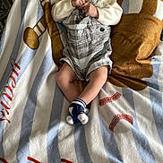 Kenny joined the competition — help win amazing prizes! baby, infant, pacifier, blanket, baseball, socks, clothing, cute, resting, indoor, soft, comfort, toddler, striped, footwear, person, portrait, child, laying, young