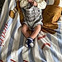 baby, infant, pacifier, blanket, baseball, socks, clothing, cute, resting, indoor, soft, comfort, toddler, striped, footwear, person, portrait, child, laying, young
