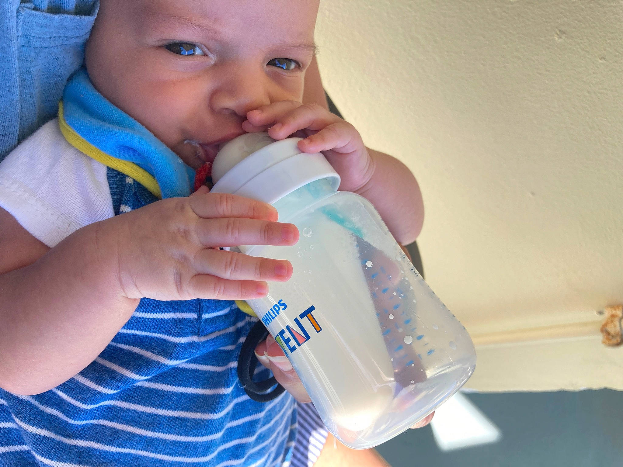 Nathan joined the competition — help win amazing prizes! baby_bottle, baby_toddler_clothing, bottle, drink, drinking, drinkware, eyelash, finger, fluid, gesture, hand, happy, headwear, liquid, milk, nail, person, plastic_bottle, skin, thumb