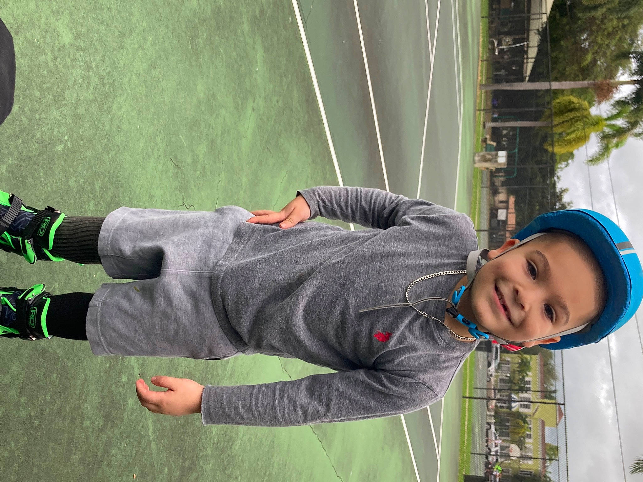 Leland is registered to the contest to win money with this photo: fun, grass, green, happy, hat, headwear, human_leg, joy, knee, leisure, person, photograph, recreation, smile, snapshot, toddler, tree