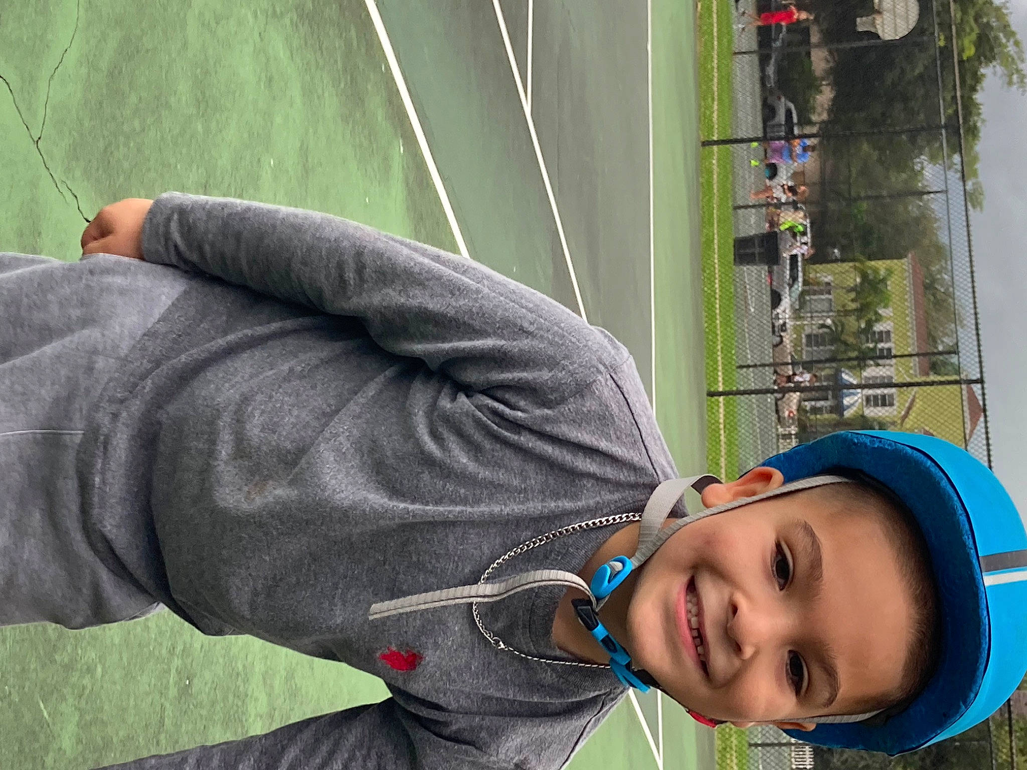 Leland is registered to the contest to win money with this photo: baseball_cap, electric_blue, fun, grass, green, happy, hat, headgear, headwear, joy, leisure, person, photograph, plant, player, product, recreation, smile, snapshot, sports