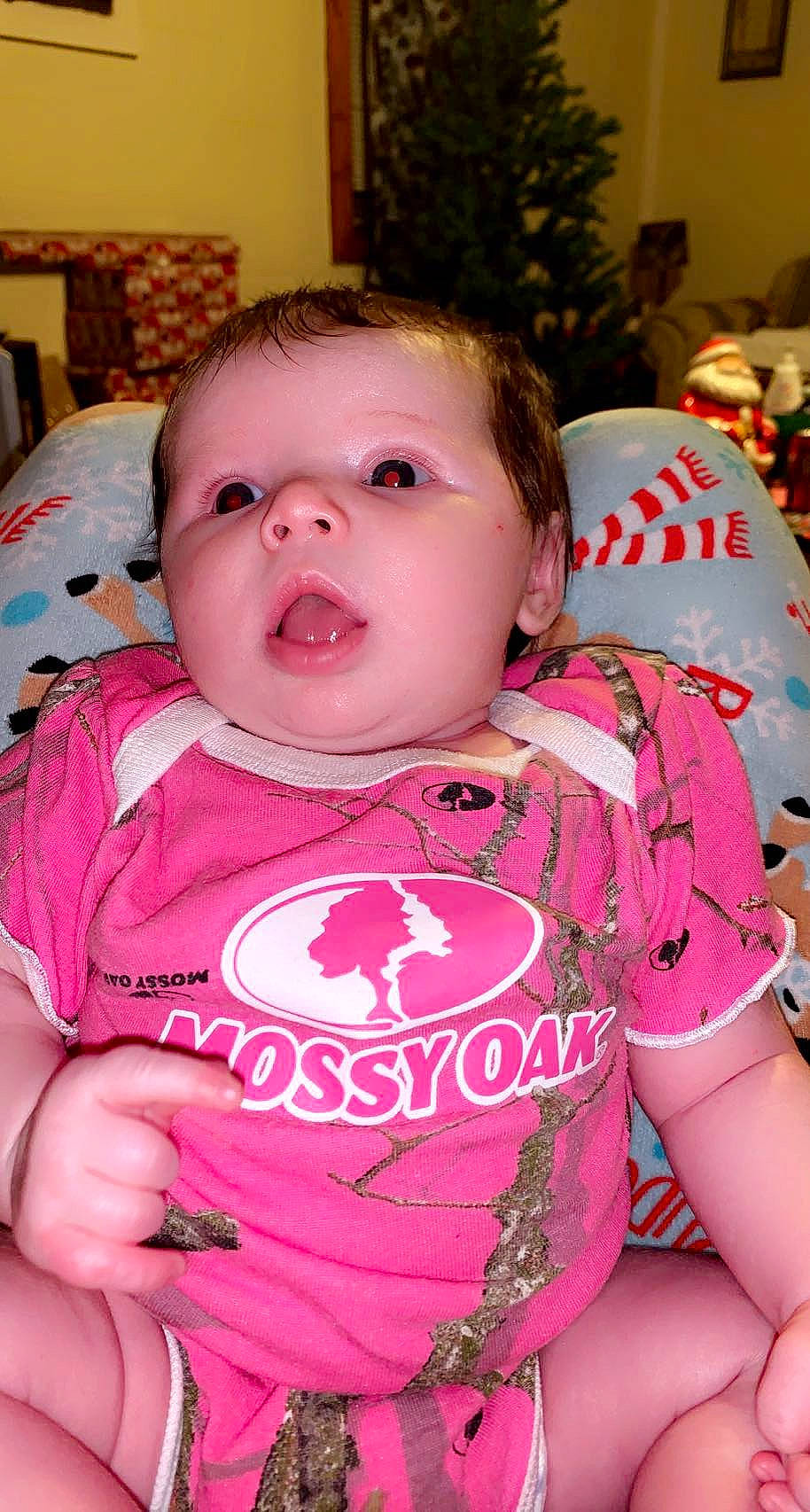 Aubrey is registered to the contest to win money with this photo: baby, baby_toddler_clothing, bib, cheek, child, eyelash, facial_expression, fun, happy, head, iris, lip, magenta, mouth, nose, person, pink, skin, sleeve, t_shirt