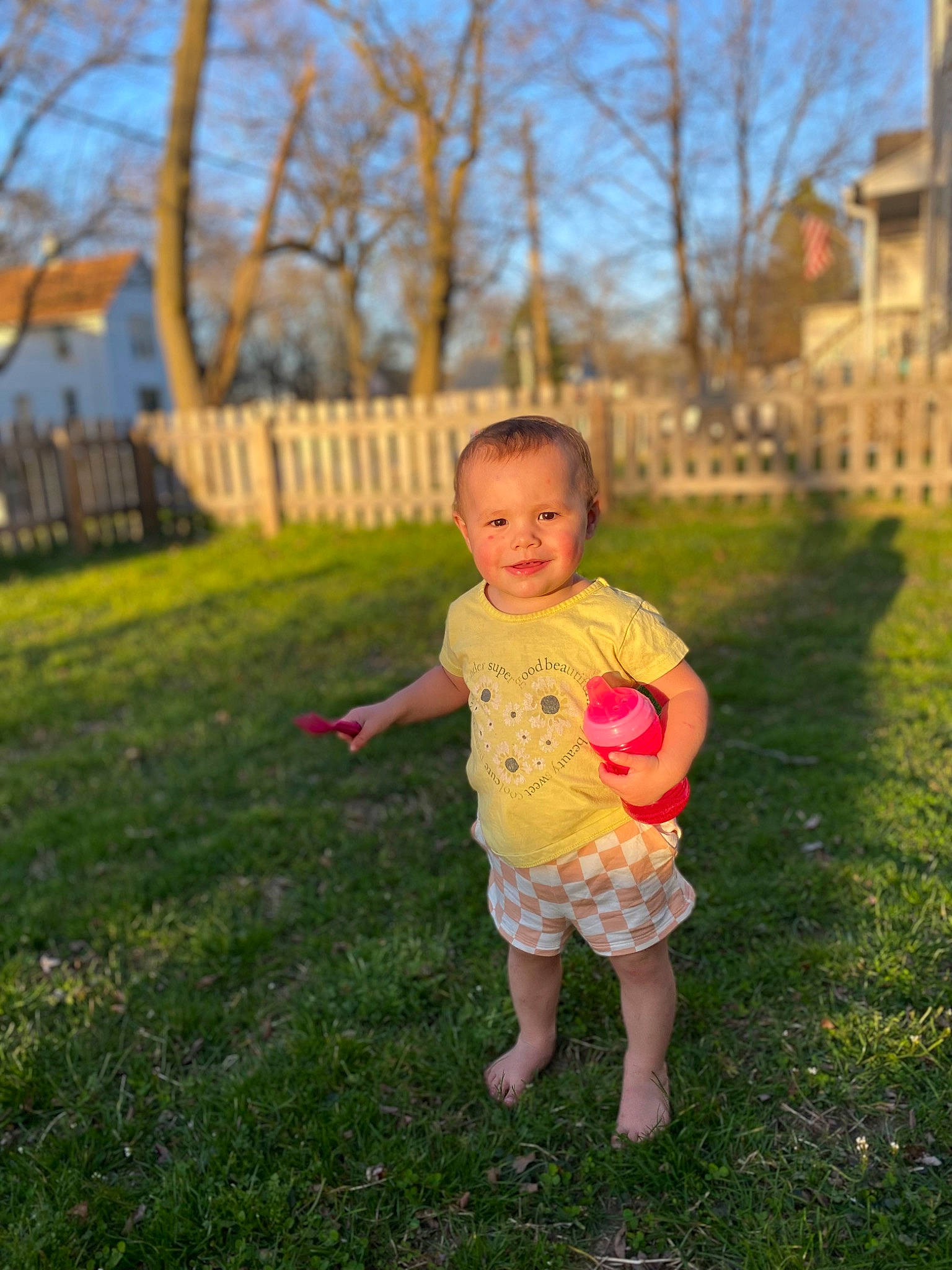Aleah is registered to the contest to win money with this photo: baby, ball, fence, gesture, grass, grassland, happy, joy, landscape, lawn, leisure, meadow, people_in_nature, person, plant, recreation, shorts, sky, smile, t_shirt