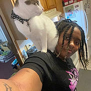 Sugarbear D. Jones joined the competition — help win amazing prizes! cat, person, shoulder, indoor, kitchen, braids, tattoo, nose_ring, black_tshirt, floor_tiles, refrigerator, cabinet, toaster, countertop, home, pet, collar, white_cat, smile, appliance