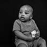 Josiah joined the competition — help win amazing prizes! baby, black_background, child, clothing, curious, cute, elephant_toy, expression, face, hands, innocence, monochrome, monochrome_photo, portrait, shorts, sitting, studio, toddler, toy, young_child