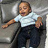toddler, child, couch, leather, gray, clothing, jeans, socks, happy, smiling, indoor, person, furniture, casual, young_child, relaxed, sitting, cute, home, portrait