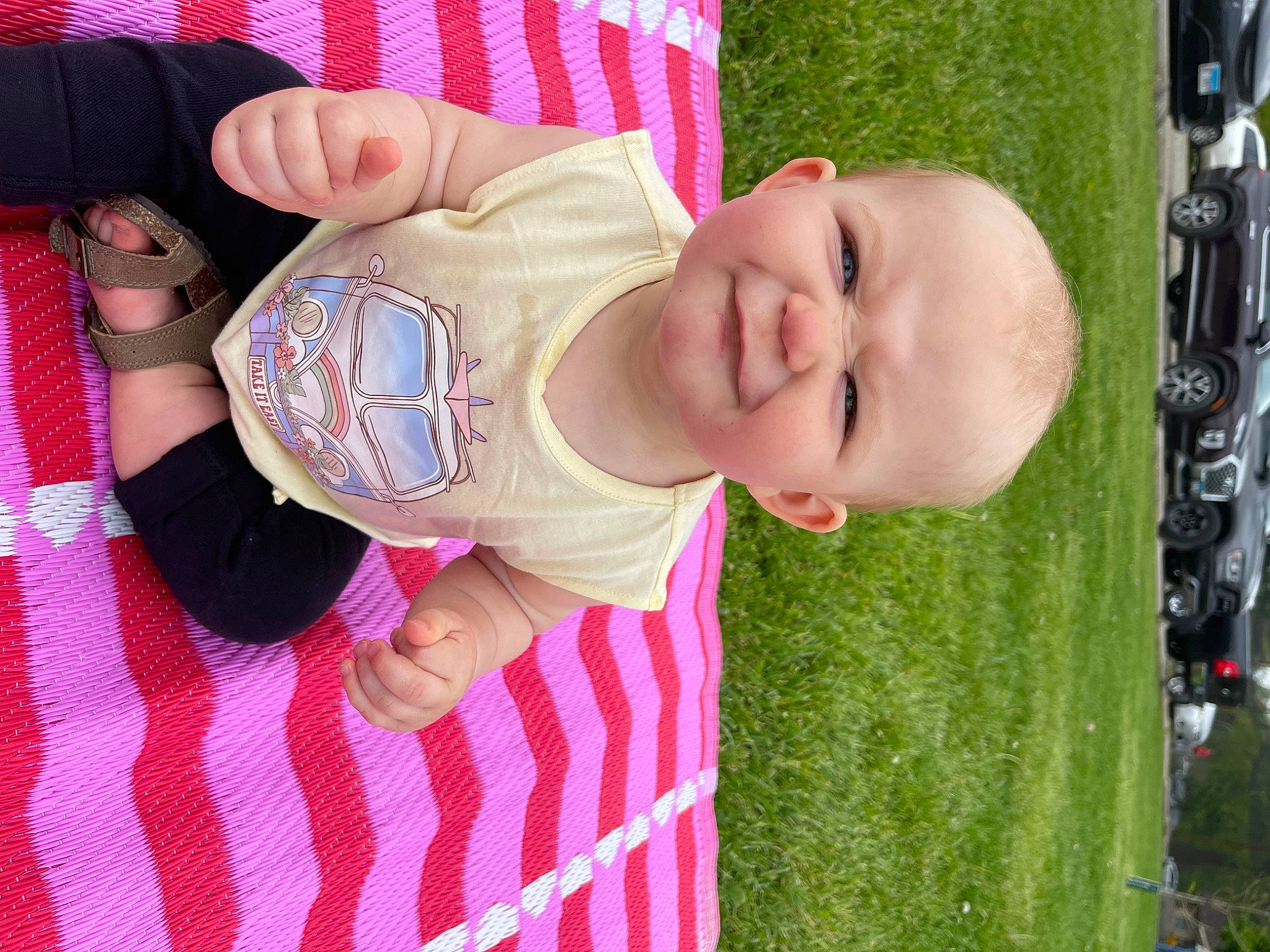 Addison is registered to the contest to win money with this photo: baby, baby_toddler_clothing, cheek, child, finger, fun, grass, green, hand, happy, human_body, joy, nose, pattern, person, pink, plant, sleeve, smile, thumb