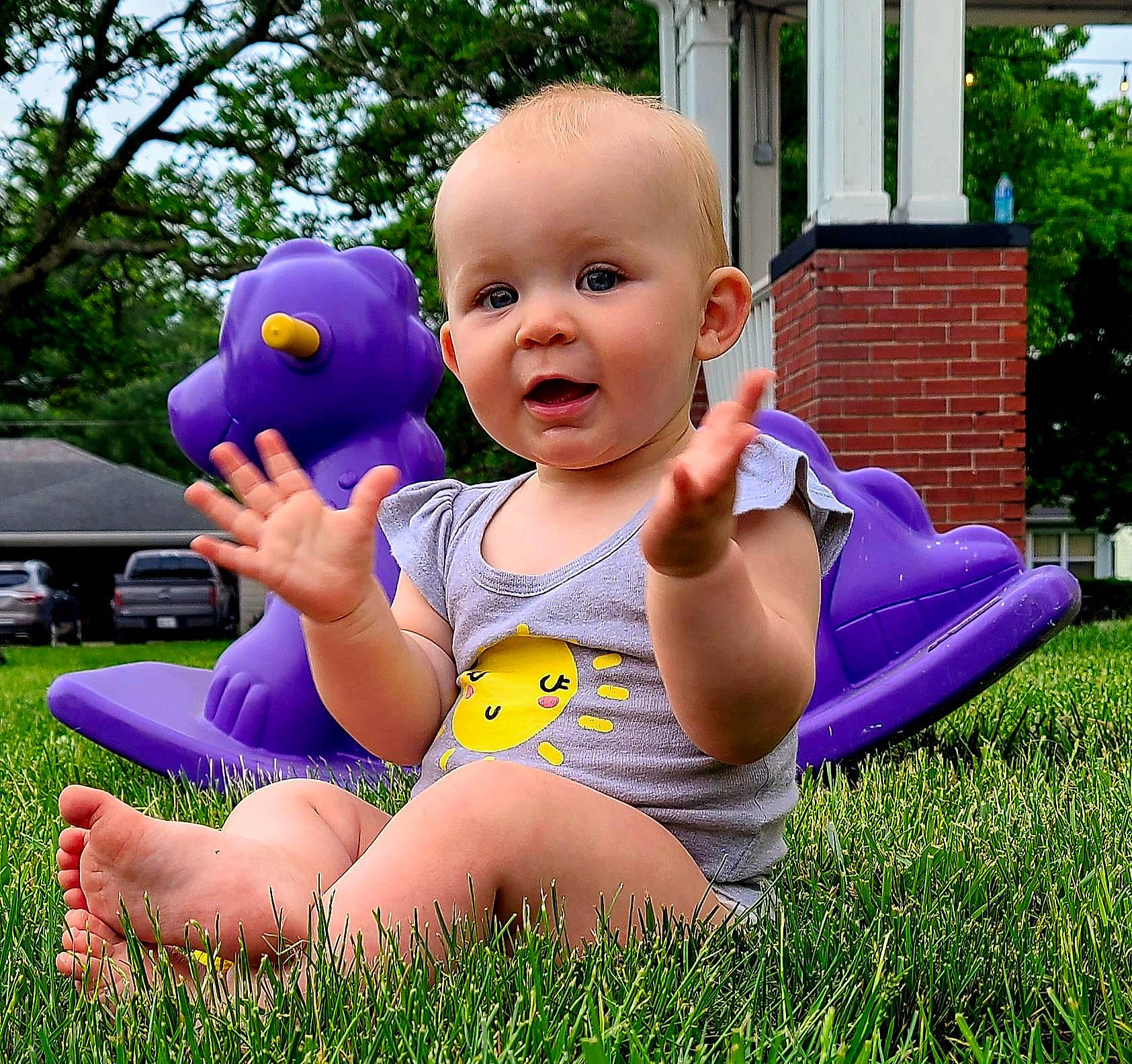 Addison joined the competition — help win amazing prizes! baby, baby_toddler_clothing, child, finger, fun, grass, happy, lawn, leisure, people_in_nature, person, pink, plant, purple, recreation, smile, thigh, thumb, toddler, toy