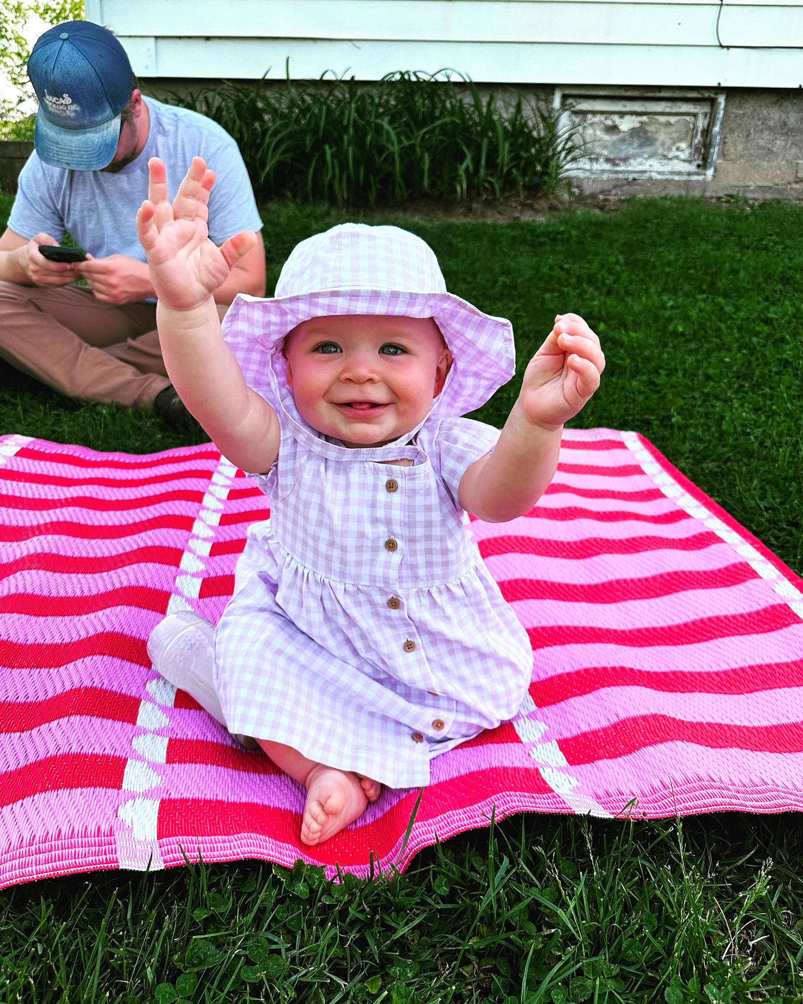 Addison is registered to the contest to win money with this photo: baby_toddler_clothing, baseball_cap, cap, child, event, fun, grass, happy, hat, headwear, joy, lap, lawn, leisure, magenta, people_in_nature, person, pink, plant, recreation