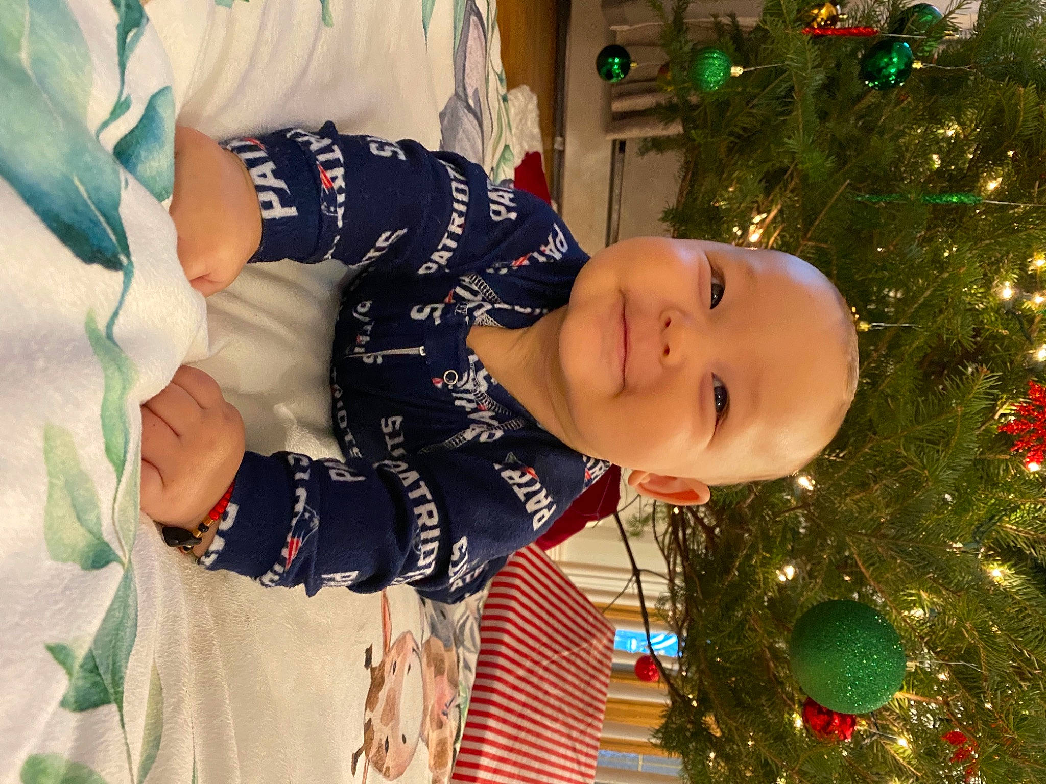 Leviticus is registered to the contest to win money with this photo: baby_toddler_clothing, child, christmas, christmas_decoration, christmas_eve, christmas_lights, christmas_ornament, christmas_tree, event, facial_expression, happy, holiday, holiday_ornament, human, interior_design, laugh, nose, ornament, person, toddler