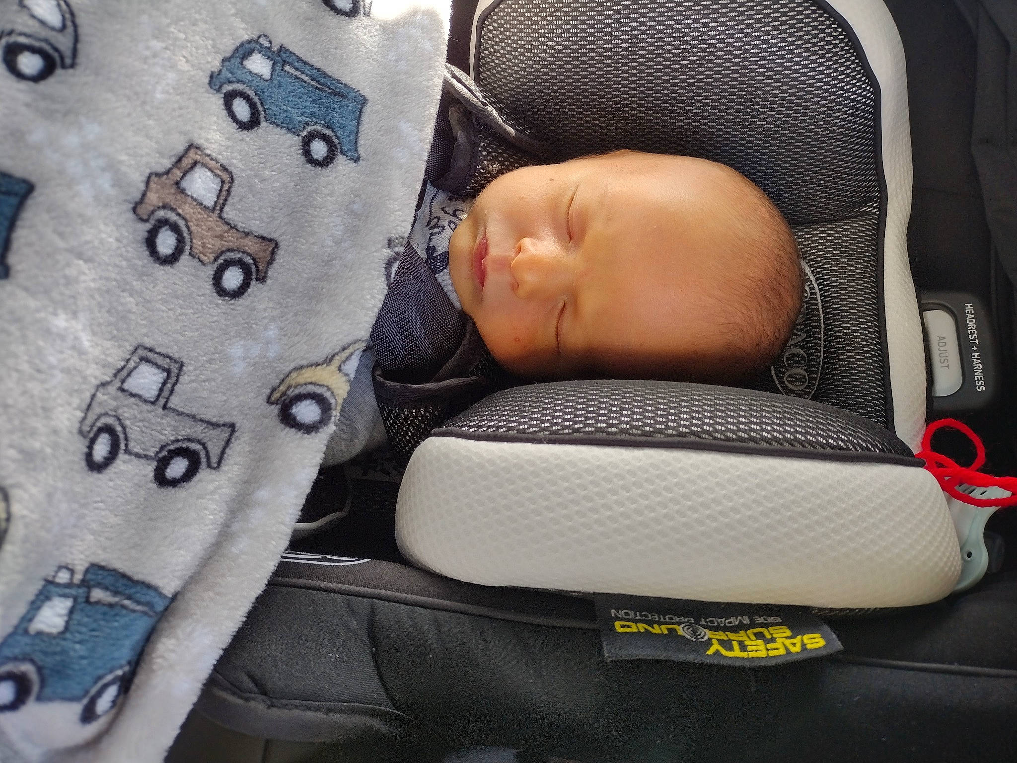 Tyson H is registered to the contest to win money with this photo: auto_part, baby, baby_products, baby_sleeping, baby_toddler_clothing, car_seat, carmine, child, comfort, electric_blue, fashion_accessory, font, linens, material_property, pattern, person, personal_protective_equipment, product, service, sleeve