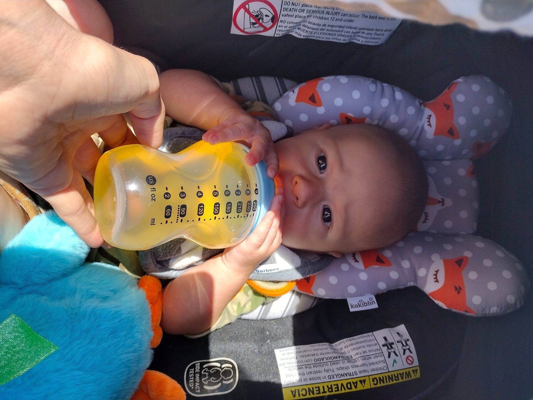 Tyson joined the competition — help win amazing prizes! baby, baby_food, baby_products, baby_toddler_clothing, baby_toys, cheek, child, drinkware, ear, finger, gesture, nail, orange, person, plastic_bottle, sitting, thumb, toddler