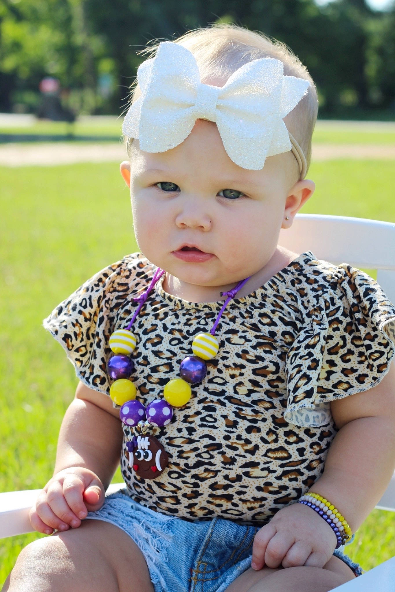 Kynsleigh is registered to the contest to win money with this photo: baby, baby_products, baby_toddler_clothing, cap, child, fashion_accessory, grass, hair_accessory, hat, headgear, lip, pattern, person, play, sitting, skin, sleeve, summer, sun_hat, toddler