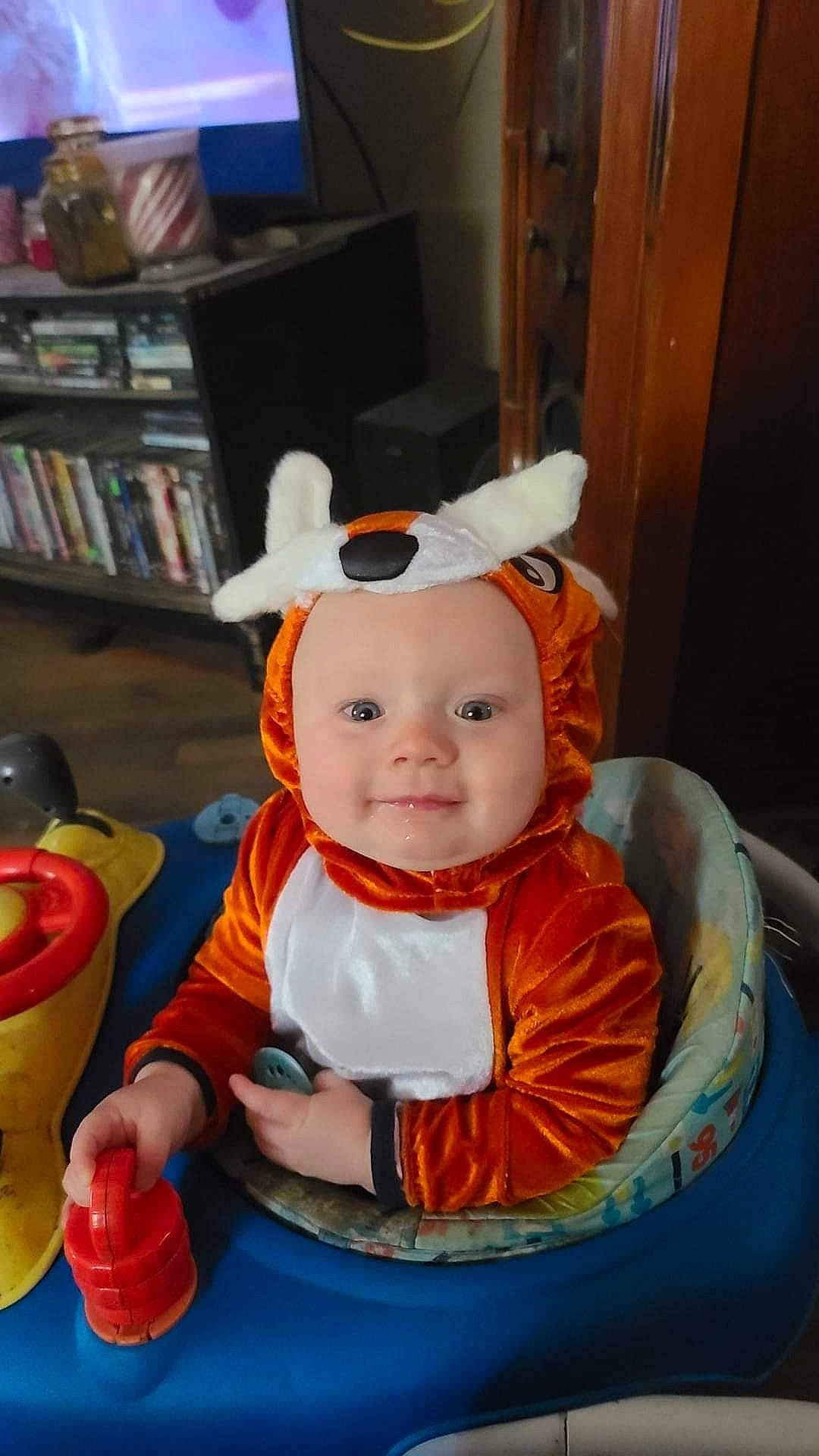 Solaire joined the competition — help win amazing prizes! baby, baby_toddler_clothing, bookcase, child, costume, door, event, fictional_character, fun, happy, hat, headwear, holiday, joy, orange, person, picture_frame, room, shelf, sitting