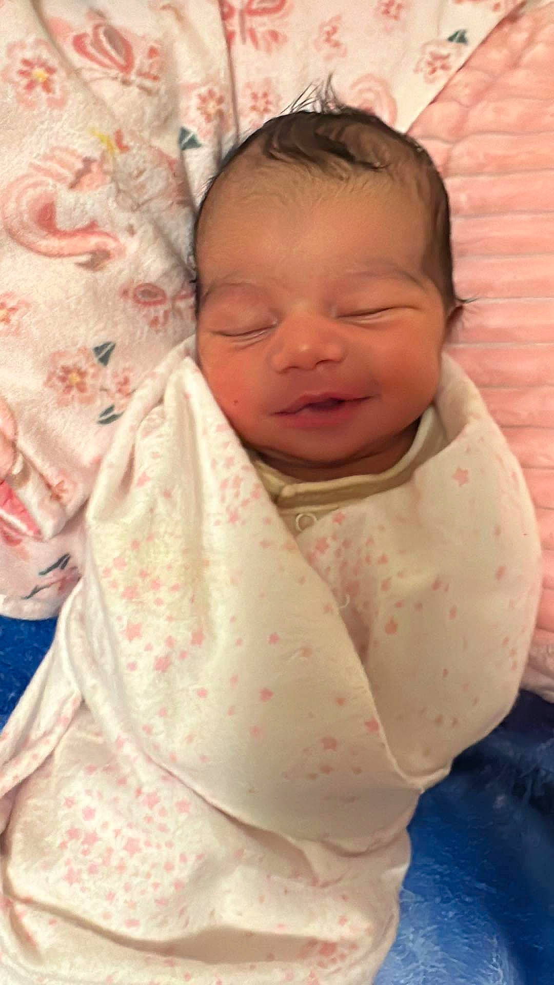 Wynter is registered to the contest to win money with this photo: baby, baby_products, baby_toddler_clothing, cheek, child, chin, comfort, event, happy, linens, pattern, peach, person, pink, skin, sleeve, smile, textile, thumb, toddler