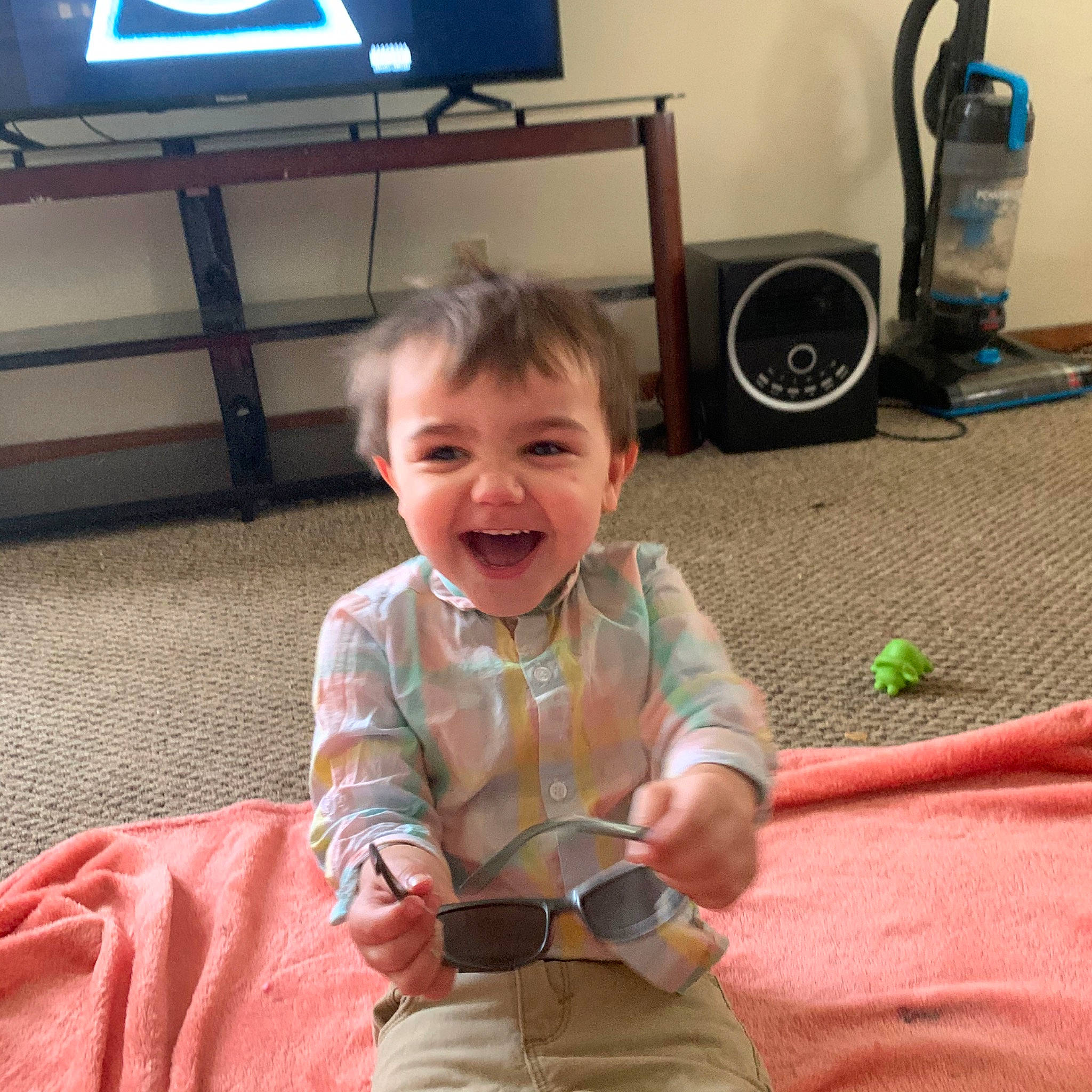 Christian is registered to the contest to win money with this photo: baby, child, cool, electronic_device, facial_expression, gadget, glasses, happy, head, joy, laugh, person, play, sitting, skin, smile, technology, toddler, tooth, vacation