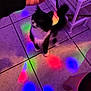 animal, black_and_white, blue_light, cat, colorful_lights, disco_lights, floor, furniture, hand, indoor, leg, motion_blur, pet, playful, purple_light, red_light, shelf, string, tile_floor, toy