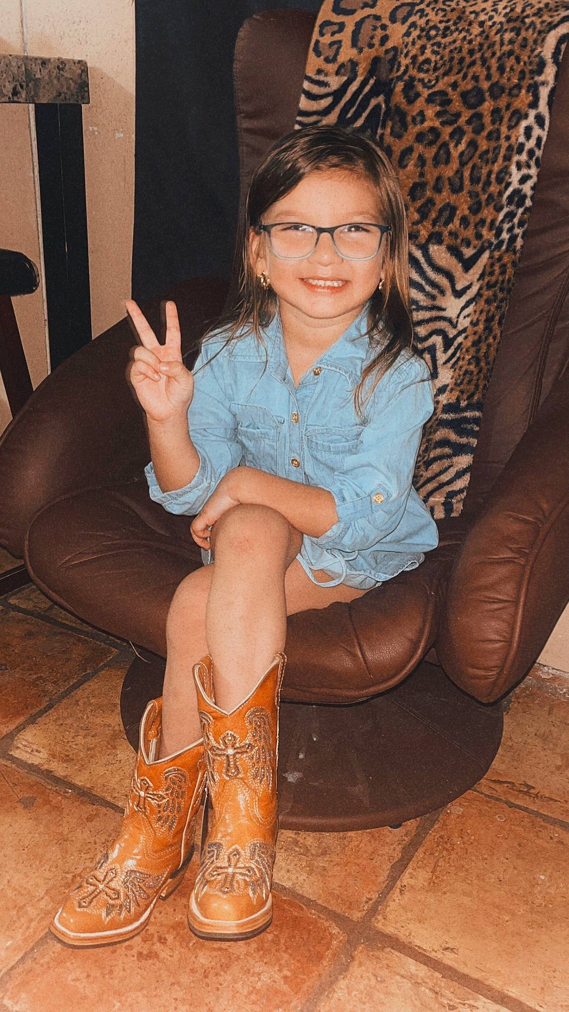 Jaiileigh is registered to the contest to win money with this photo: black_hair, brown_hair, calf, comfort, cool, couch, face, flash_photography, foot, glasses, hair, human_body, human_leg, joint, joy, knee, knee_high_boot, leg, long_hair, person