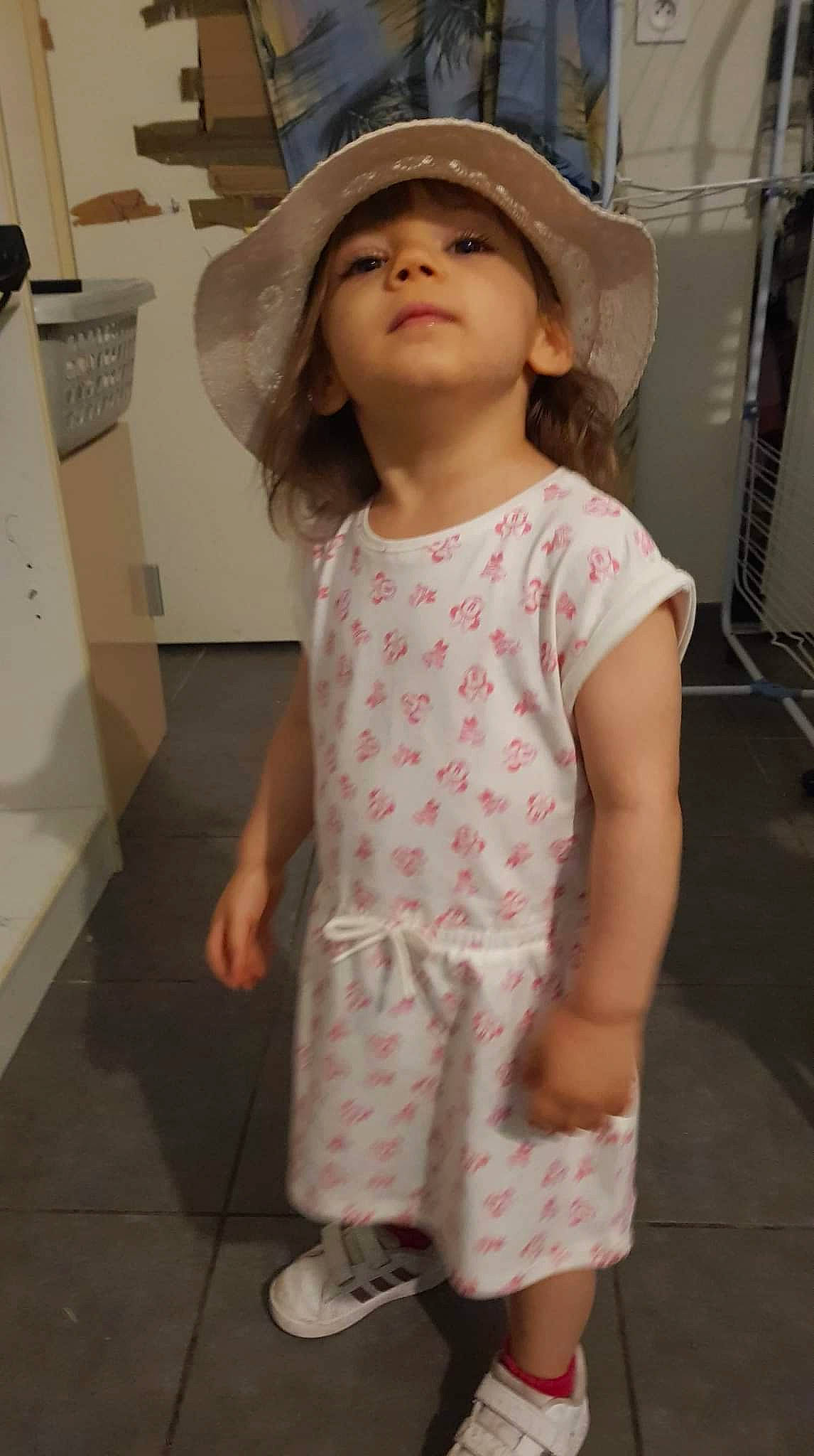 Kyara participe au concours pour gagner de l'argent avec cette photo : baby_toddler_clothing, cap, day_dress, eye, face, fashion_design, happy, hat, headwear, joint, pattern, person, pink, shoulder, sleeve, standing, street_fashion, sun_hat, toddler, trunk