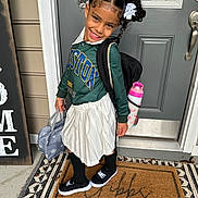 Elliana joined the competition — help win amazing prizes! accessories, bag, blackhair, bottle, child, clothing, doormat, face, female, footwear, girl, hair, handbag, head, mat, person, photography, shaker, shoe, skirt