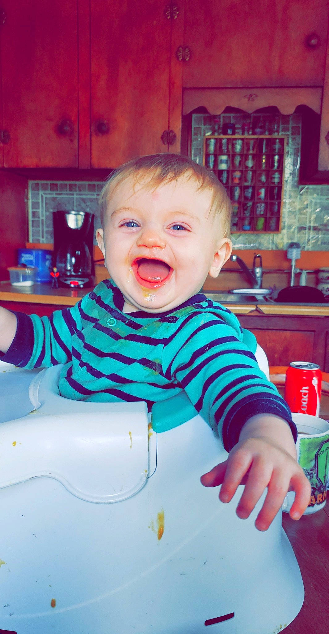 Niko is registered to the contest to win money with this photo: baby, cheek, child, eating, eye, face, facial_expression, fun, happy, head, iris, lip, mouth, person, pink, play, room, sitting, skin, smile