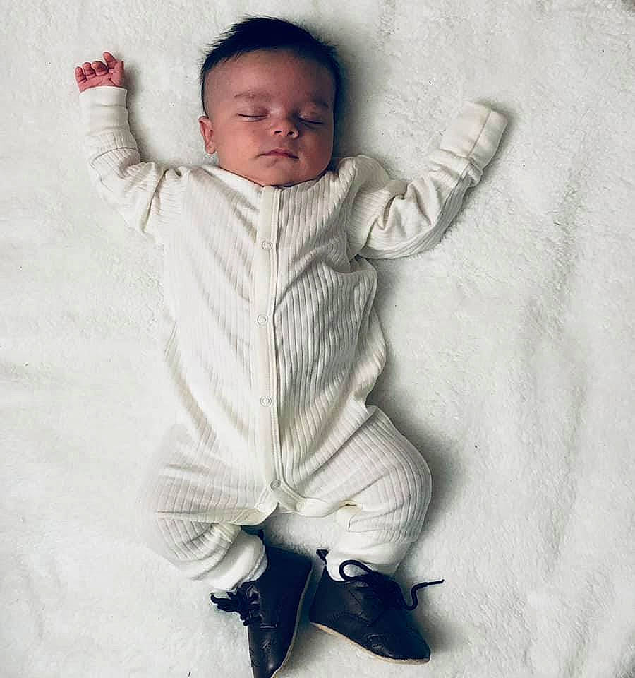 Nehemias is registered to the contest to win money with this photo: art, baby, baby_toddler_clothing, child, comfort, finger, fur, gesture, hand, happy, insect, linens, pattern, person, portrait_photography, sitting, sleeve, smile, thumb, toddler