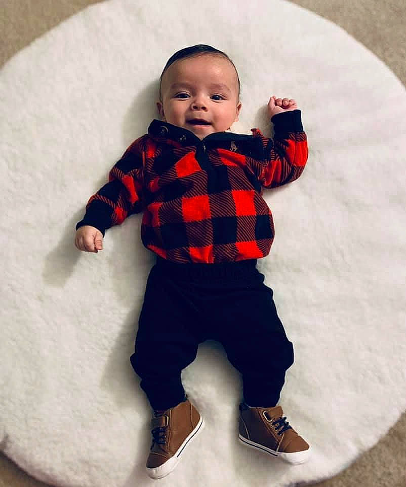 Nehemias is registered to the contest to win money with this photo: arm, baby, baby_toddler_clothing, child, collar, doll, dress_shirt, eye, face, head, human_body, neck, outerwear, pattern, person, plaid, sleeve, tartan, textile, toddler