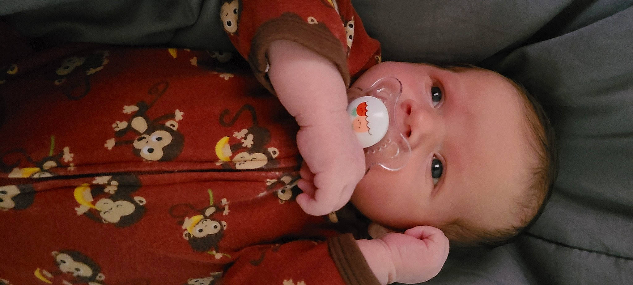 Benjamin is registered to the contest to win money with this photo: arm, baby, baby_toddler_clothing, brown, cheek, chin, ear, eyebrow, eyelash, hand, human_body, iris, lip, mammal, mouth, neck, nose, person, skin, textile