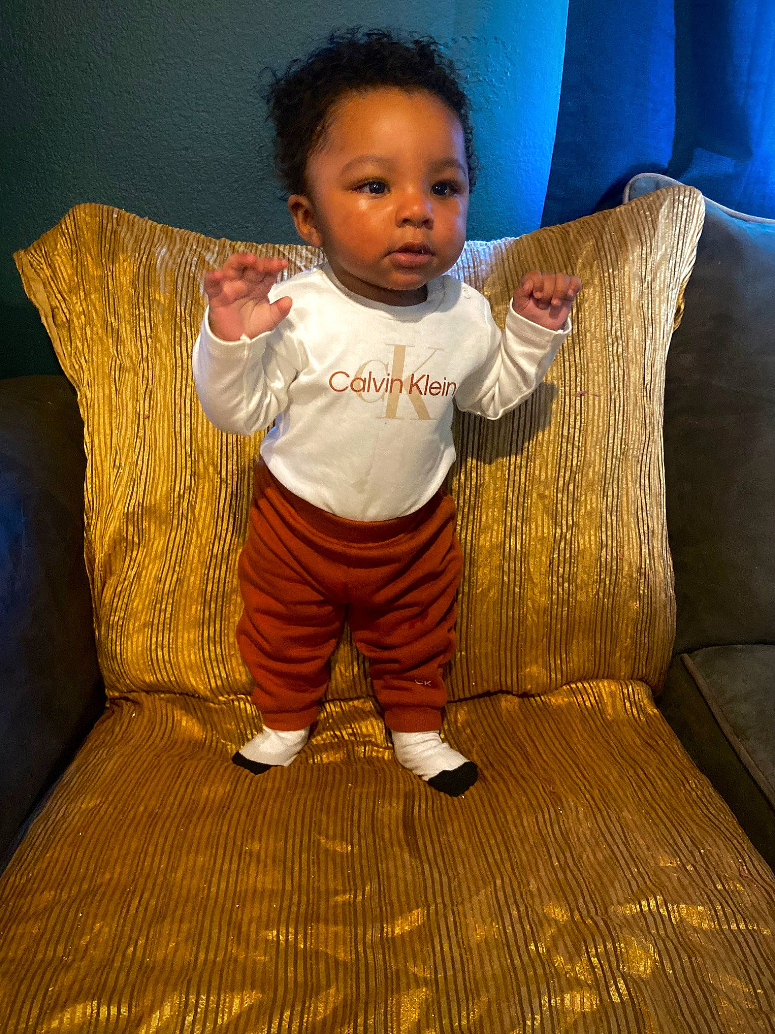 Armonie joined the competition — help win amazing prizes! baby, baby_toddler_clothing, child, comfort, couch, eye, face, flooring, fun, happy, hardwood, living_room, person, pillow, rectangle, room, sitting, sleeve, throw_pillow, toddler