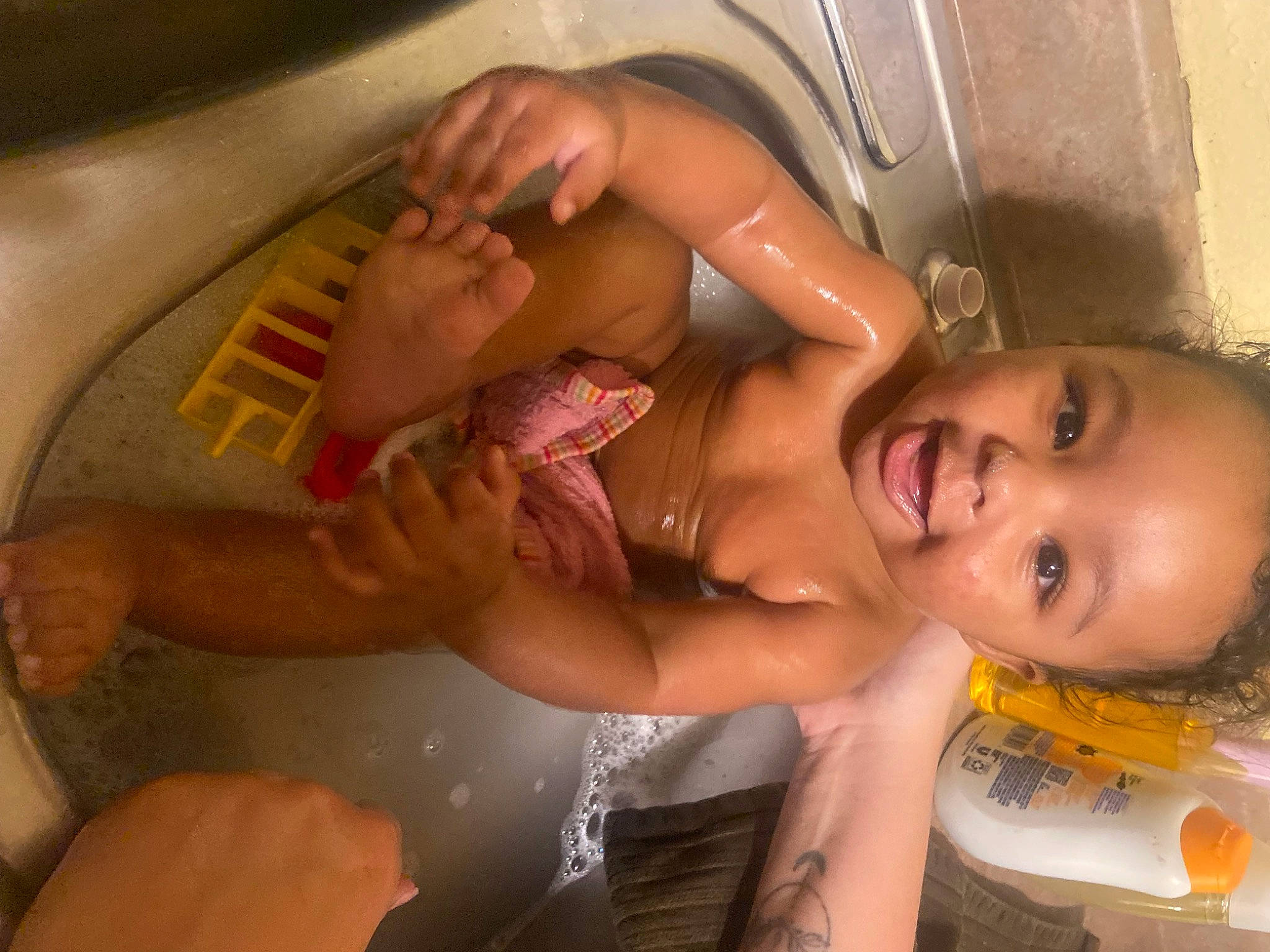 Armonie is registered to the contest to win money with this photo: arm, baby, bathing, black_hair, cheek, chest, ear, eyebrow, finger, hand, happy, human_body, mouth, muscle, neck, nose, person, skin, stomach, toddler