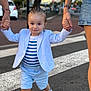 toddler, child, holding_hands, walking, street, crosswalk, blue_shorts, striped_shirt, blazer, sneakers, adult_hands, outdoor, daytime, fashion, cute, person, urban, sidewalk, casual, happy