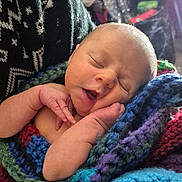 Luna is registered to the contest to win money with this photo: newborn, baby, sleeping, blanket, knitted, hand, face, closeup, infant, cozy, warm, pattern, sweater, indoor, person, portrait, soft, cute, peaceful, resting