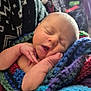 newborn, baby, sleeping, blanket, knitted, hand, face, closeup, infant, cozy, warm, pattern, sweater, indoor, person, portrait, soft, cute, peaceful, resting