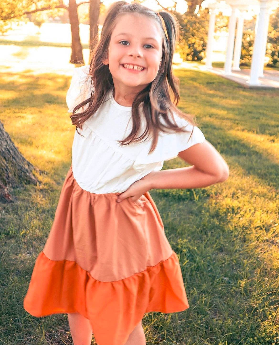 Kayci is registered to the contest to win money with this photo: day_dress, face, facial_expression, fawn, flash_photography, grass, hair, hairstyle, happy, joy, leaf, nature, orange, outerwear, people, people_in_nature, person, plant, sleeve, smile