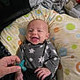 Carson joined the competition — help win amazing prizes! baby, smiling, onesie, star_pattern, pacifier, hand, cushion, polka_dot, fabric, bag, clothing, infant, happy, portrait, indoor, sleepwear, person, cute, child, newborn