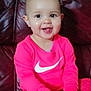 Assia a rejoint le concours — aidez-le/la à gagner de superbes lots ! child, baby, infant, sitting, smile, tongue, pink_clothing, long_sleeve, leggings, socks, toy, hand, face, eyes, leather_sofa, couch, home_interior, cute, nike_logo, closeup