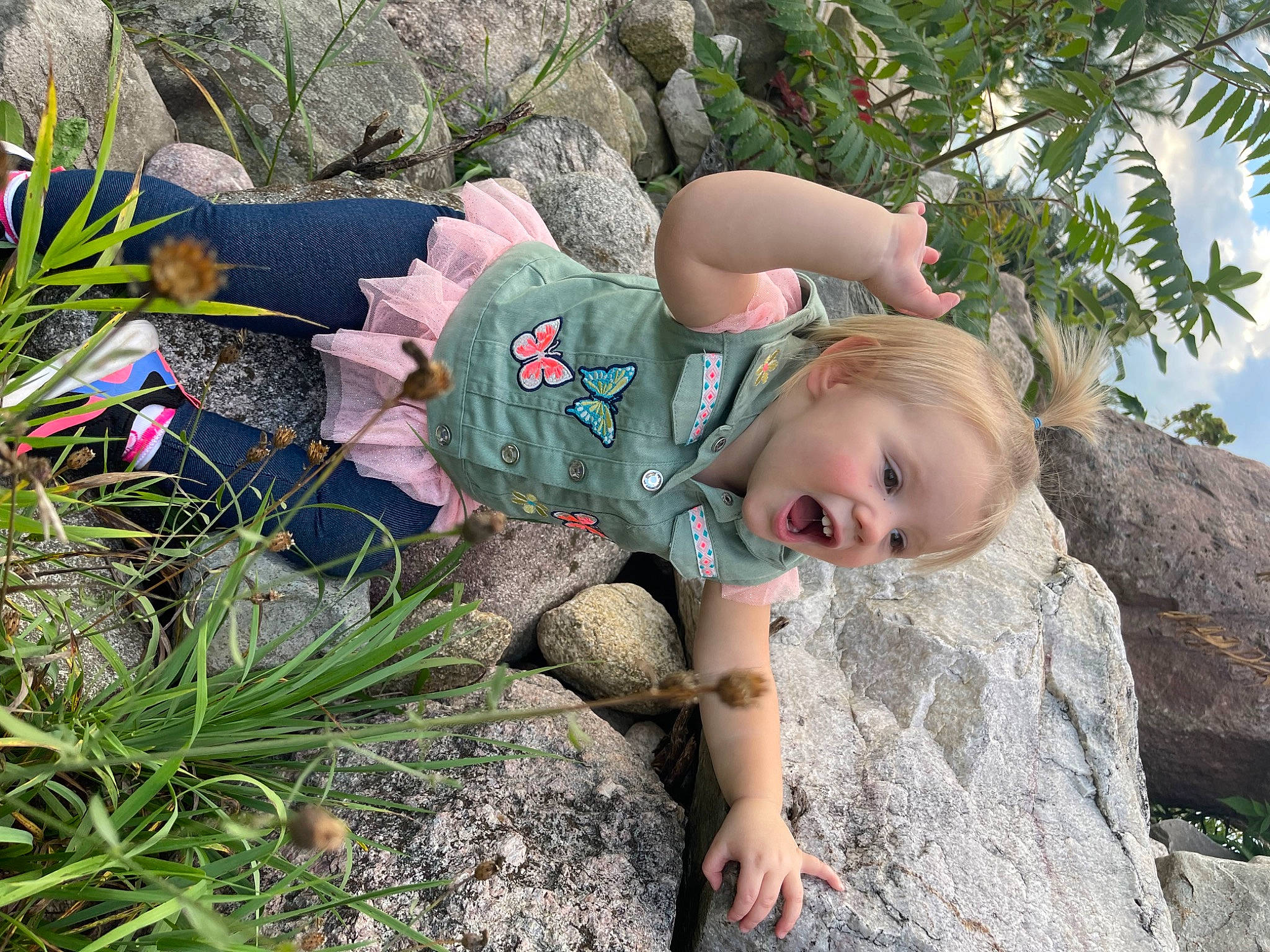 Wrenley joined the competition — help win amazing prizes! bedrock, child, fawn, fun, garden, grass, grass_family, happy, landscape, leisure, people_in_nature, person, plant, recreation, rock, sitting, sunglasses, toddler, tree, vacation