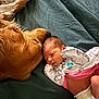 Hazeleigh joined the competition — help win amazing prizes! baby, newborn, infant, dog, golden_retriever, pet, bed, blanket, cuddling, face, paw, diaper, onesie, rainbow_print, cozy, sleeping, cute, family, indoor, portrait