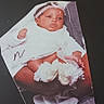 baby, infant, cutout_photo, white_clothing, headband, hands, feet, adult_hands, background, black_background, text_overlay, sentimental, portrait, clothing, infant_booties, photograph, keepsake, close_up, human, person