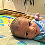 Elijah is registered to the contest to win money with this photo: baby, child, closeup, clothing, colorful, curious, eyes, face, floor, hand, head, home, indoor, infant, newborn, person, play_mat, portrait, skin, soft