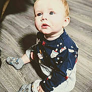 Owen Swartz joined the competition — help win amazing prizes! baby, child, infant, sitting, portrait, indoors, floor, wood_floor, pajamas, blue_clothing, socks, cartoon_pattern, winter_theme, wide_eyed, looking_up, sunlight, shadow, adorable, home, photography